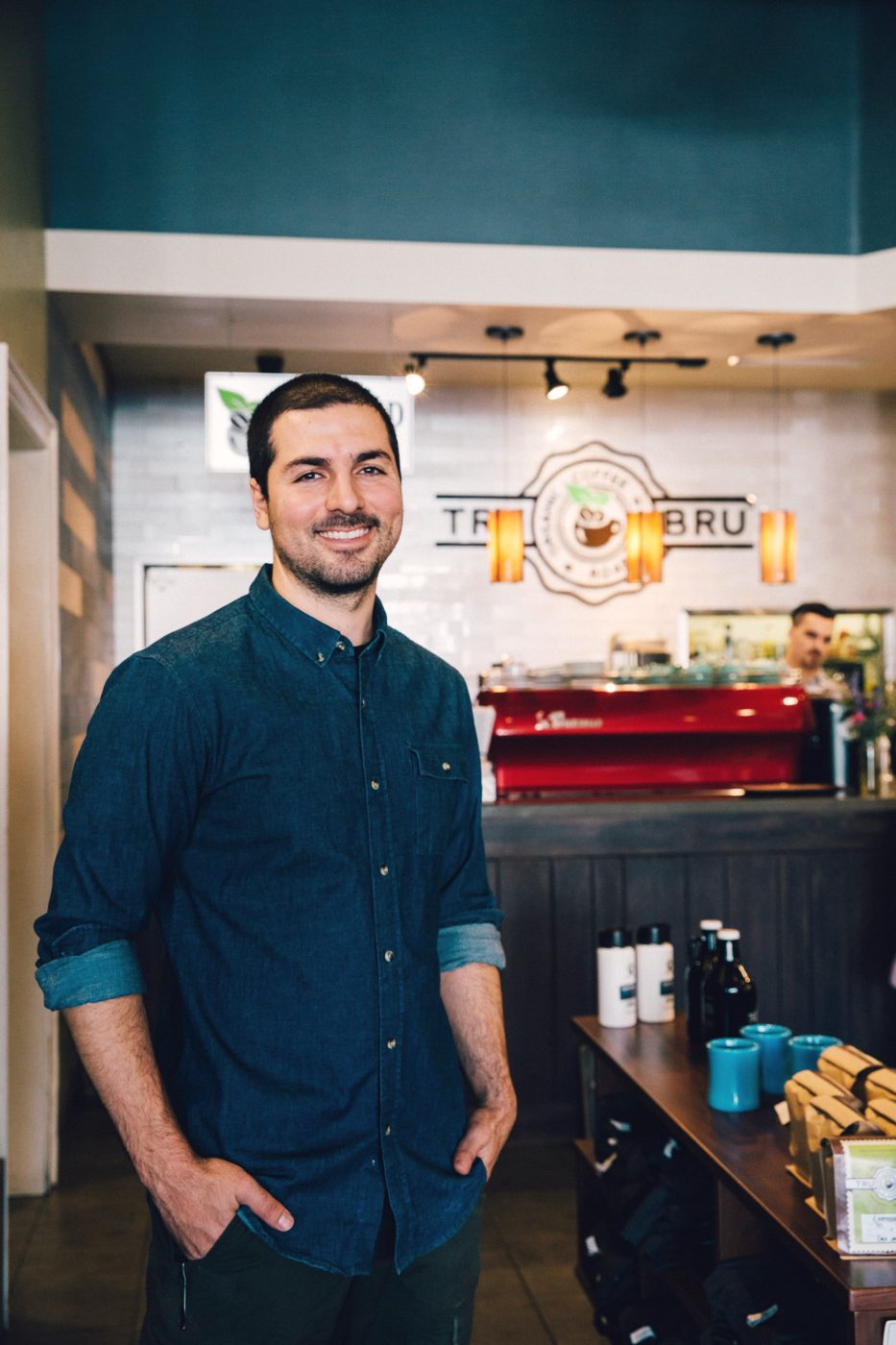 Nick Kassouf standing in front of the espresso bar at Tru Bru Organic Coffee
