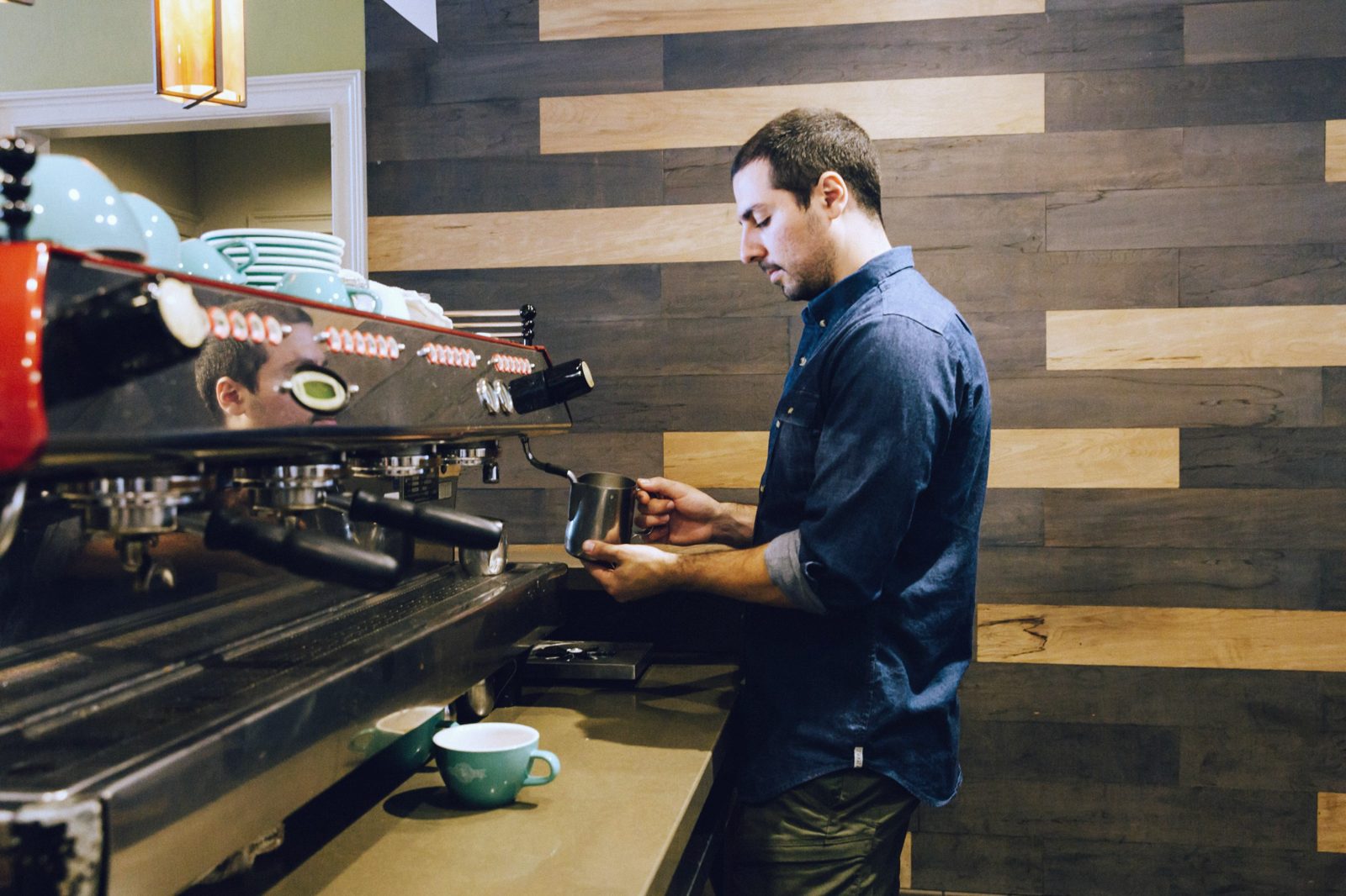 Nick steaming milk at the espresso machine